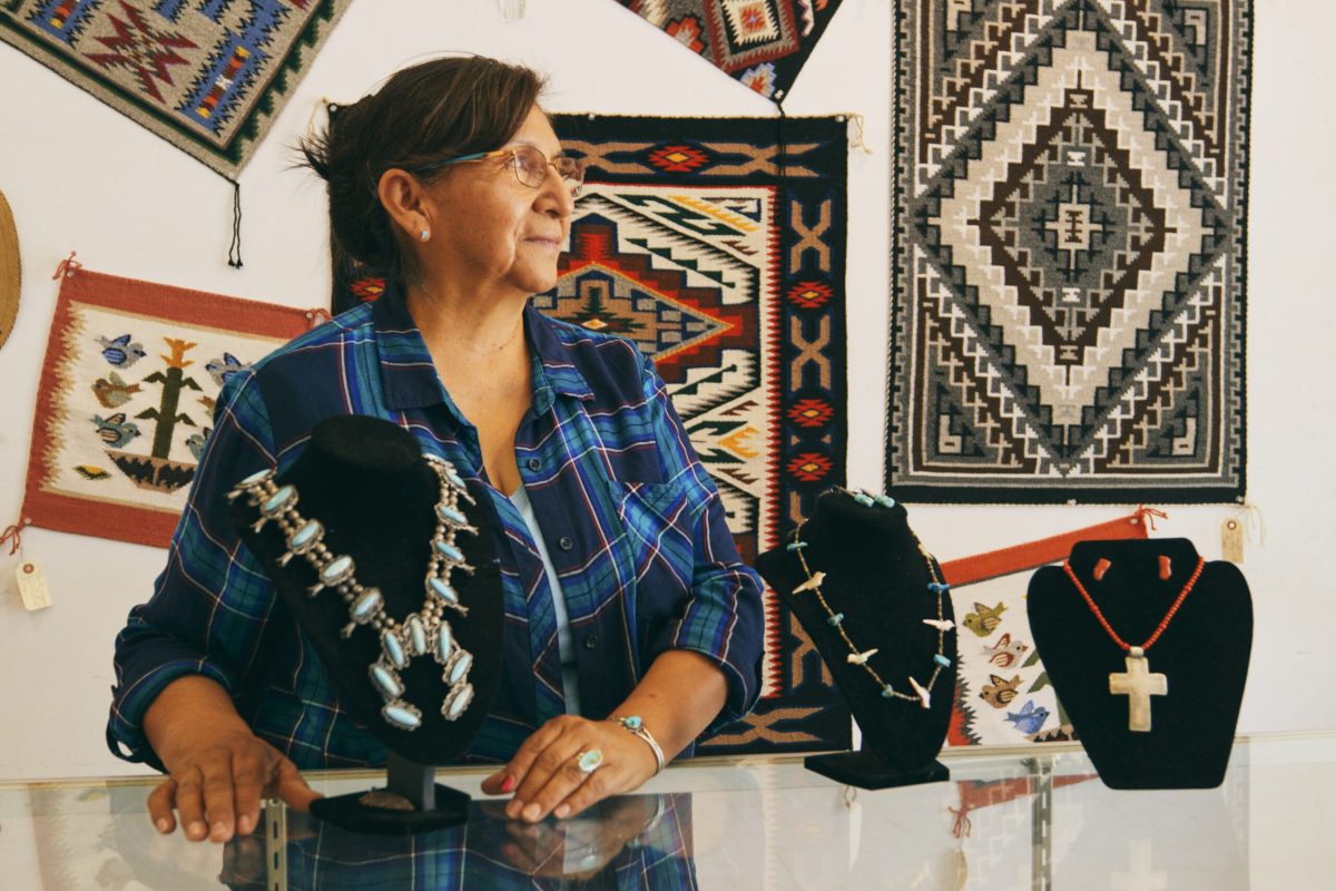 A female Indigenous Navajo small business owner at work in her jewelry shop.